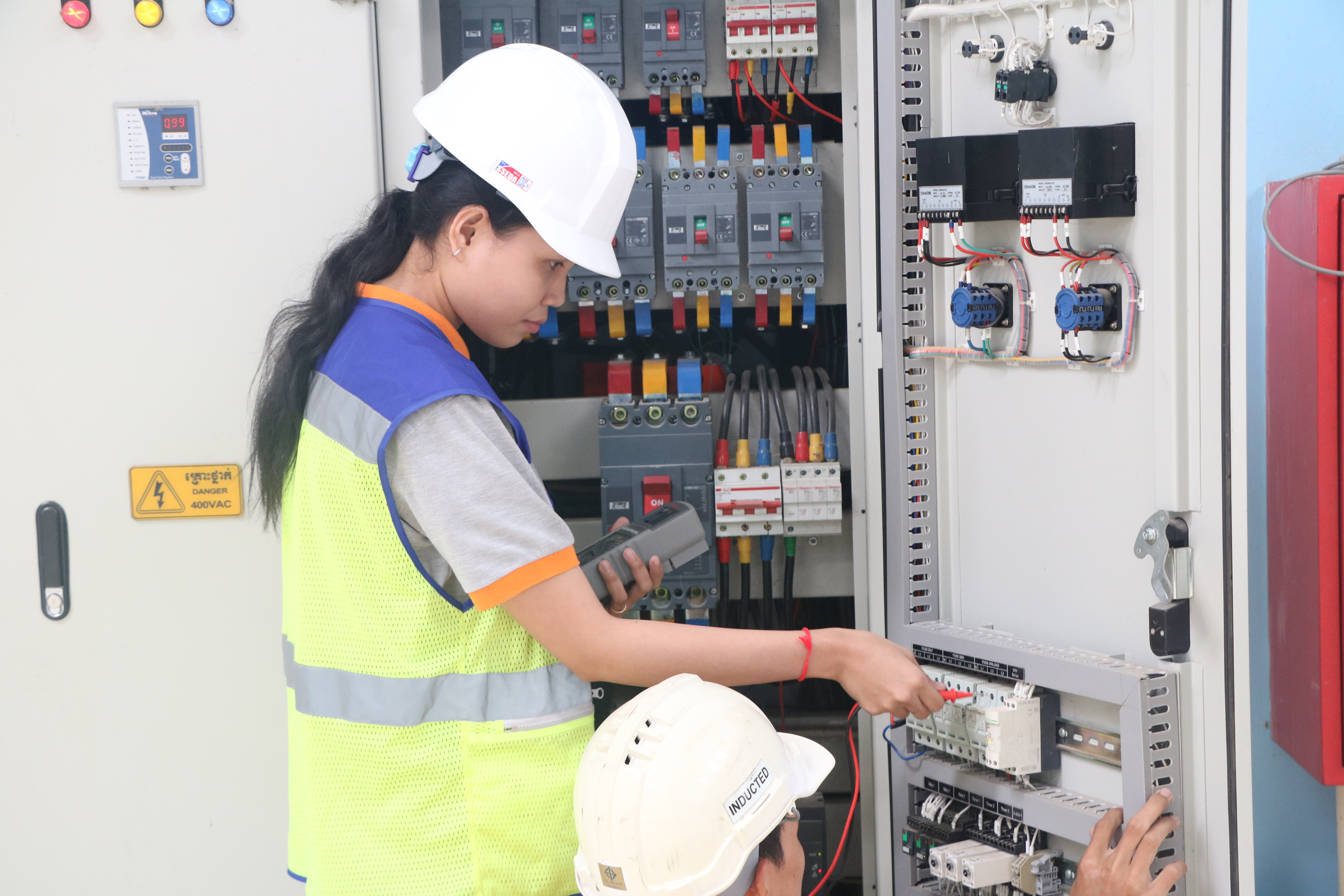 Electrical Technician Working on Panel